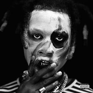 Album cover art with Denzel menacingly leering toward the camera in smudged black and white face paint